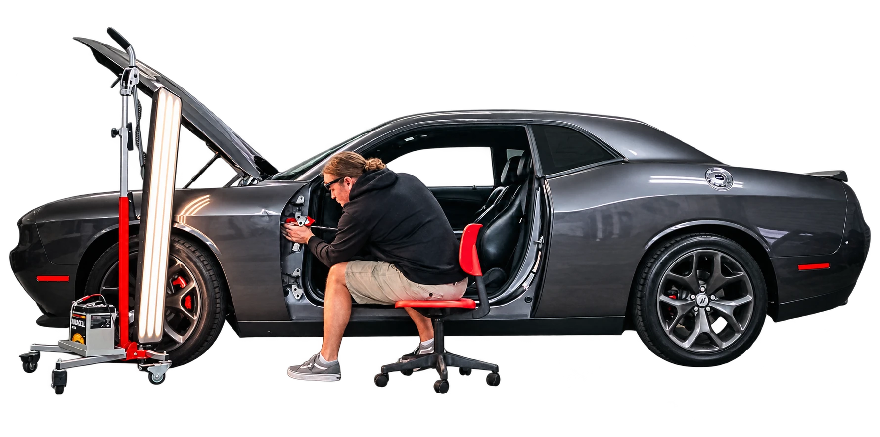 Pro Dent technician working on a gray Dodge Challenger with a PDR inspection light